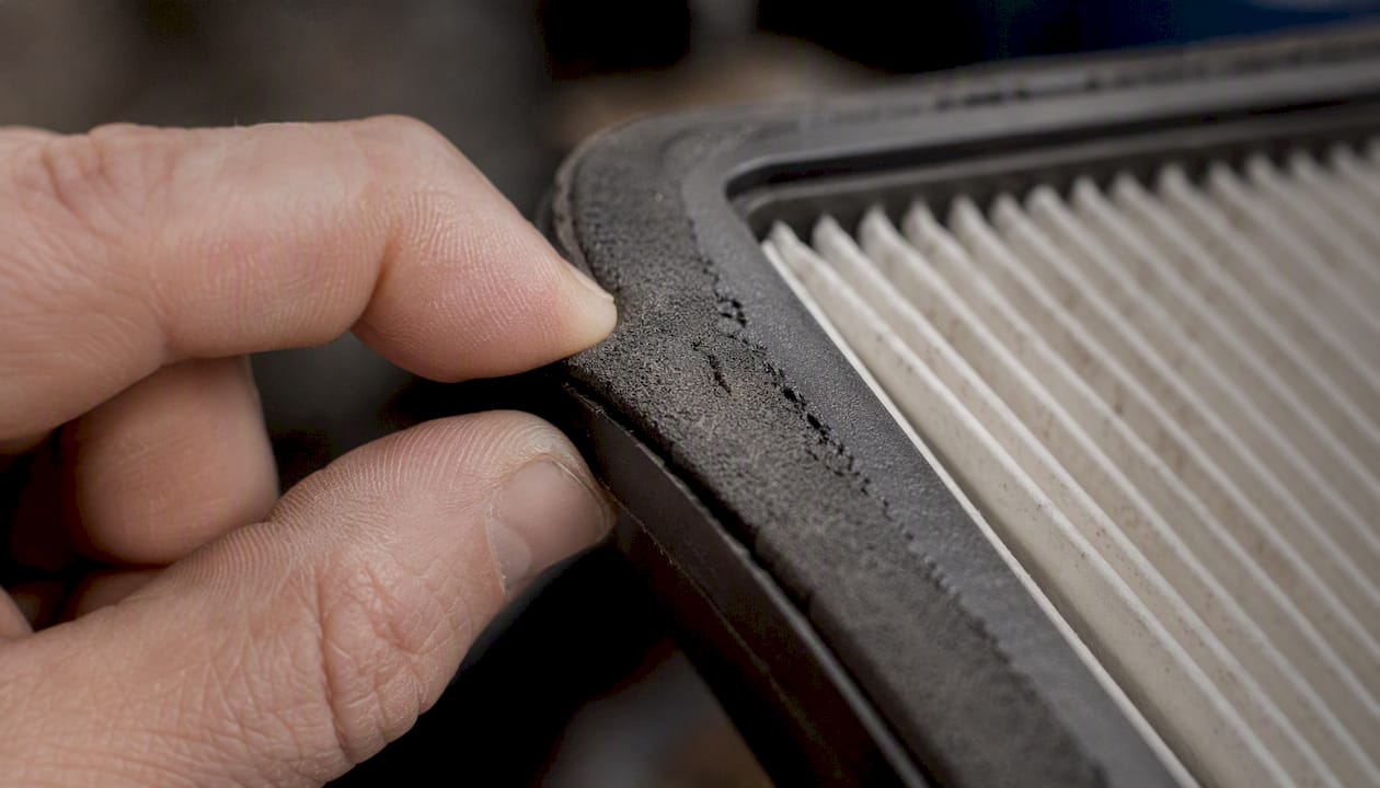 Close-up of air filter frame gasket wear inspection