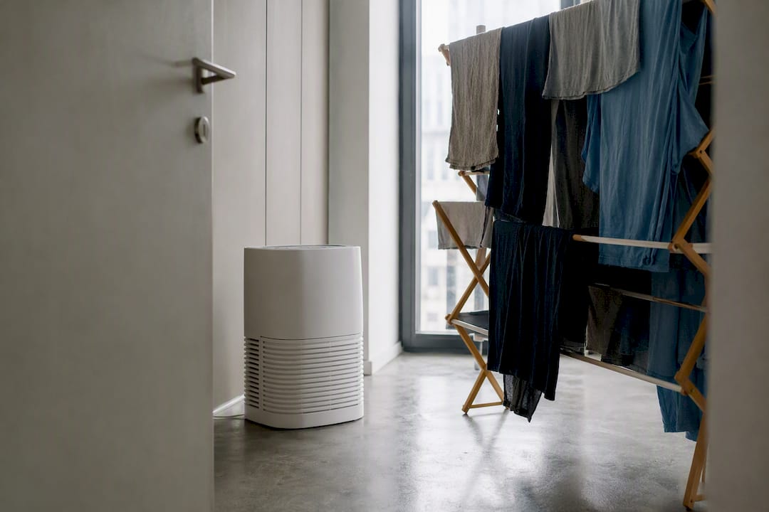 Laundry drying indoors with dehumidifier running